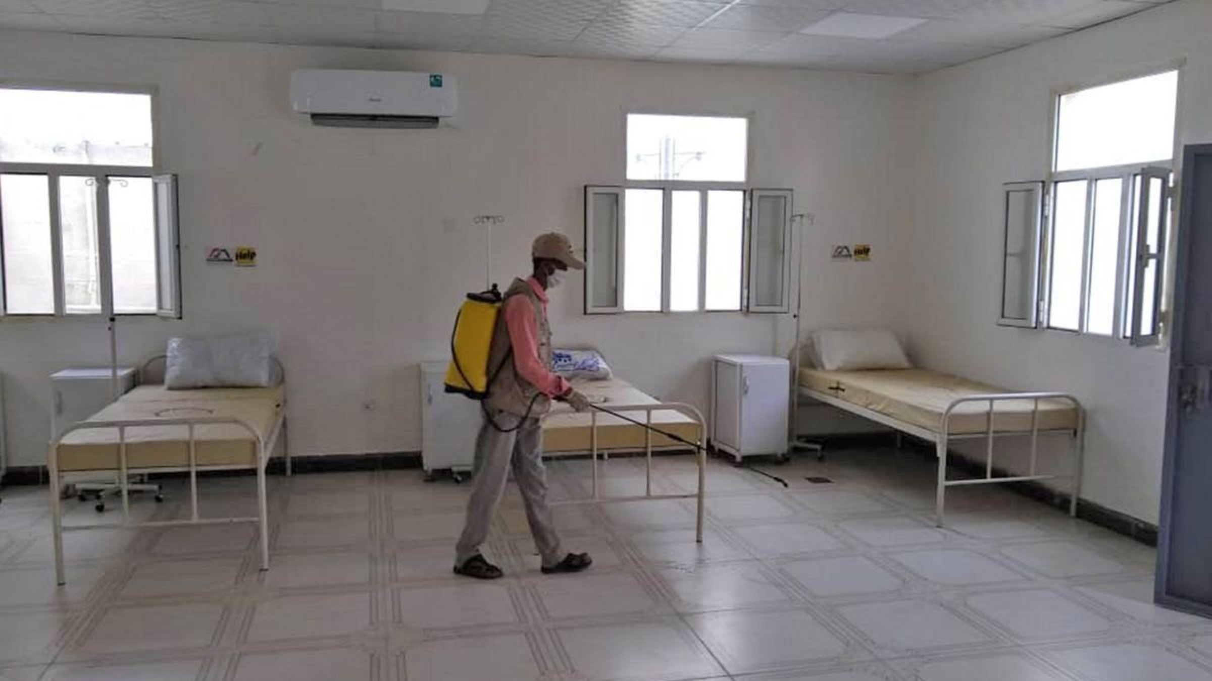 A man disinfects a medical station in Yemen.